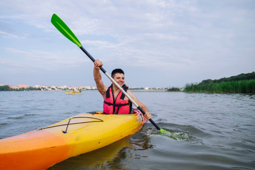 male kayaker paddling kayak lake